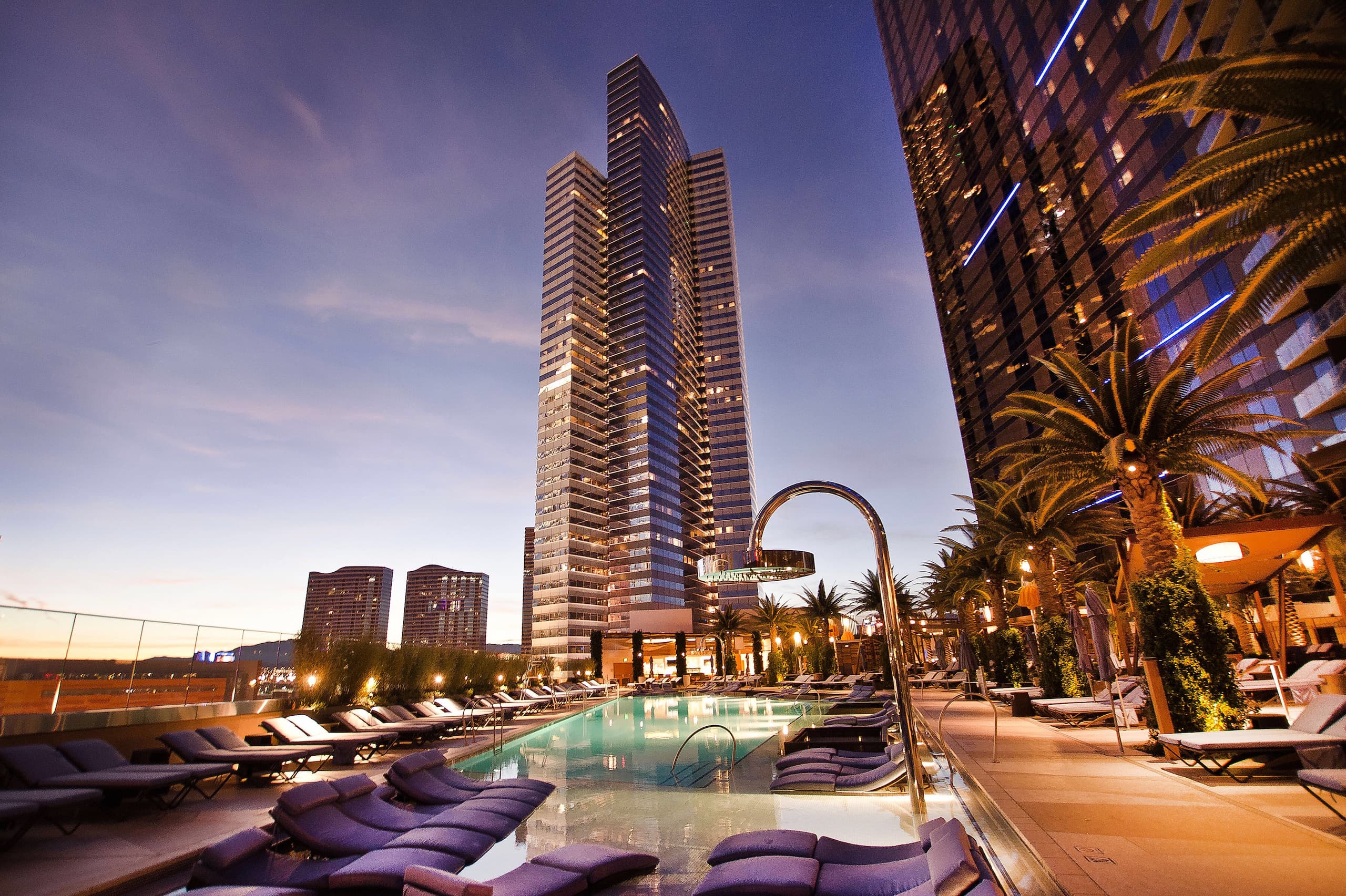 illuminated-modern-buildings-by-swimming-pool-against-sky-city-1