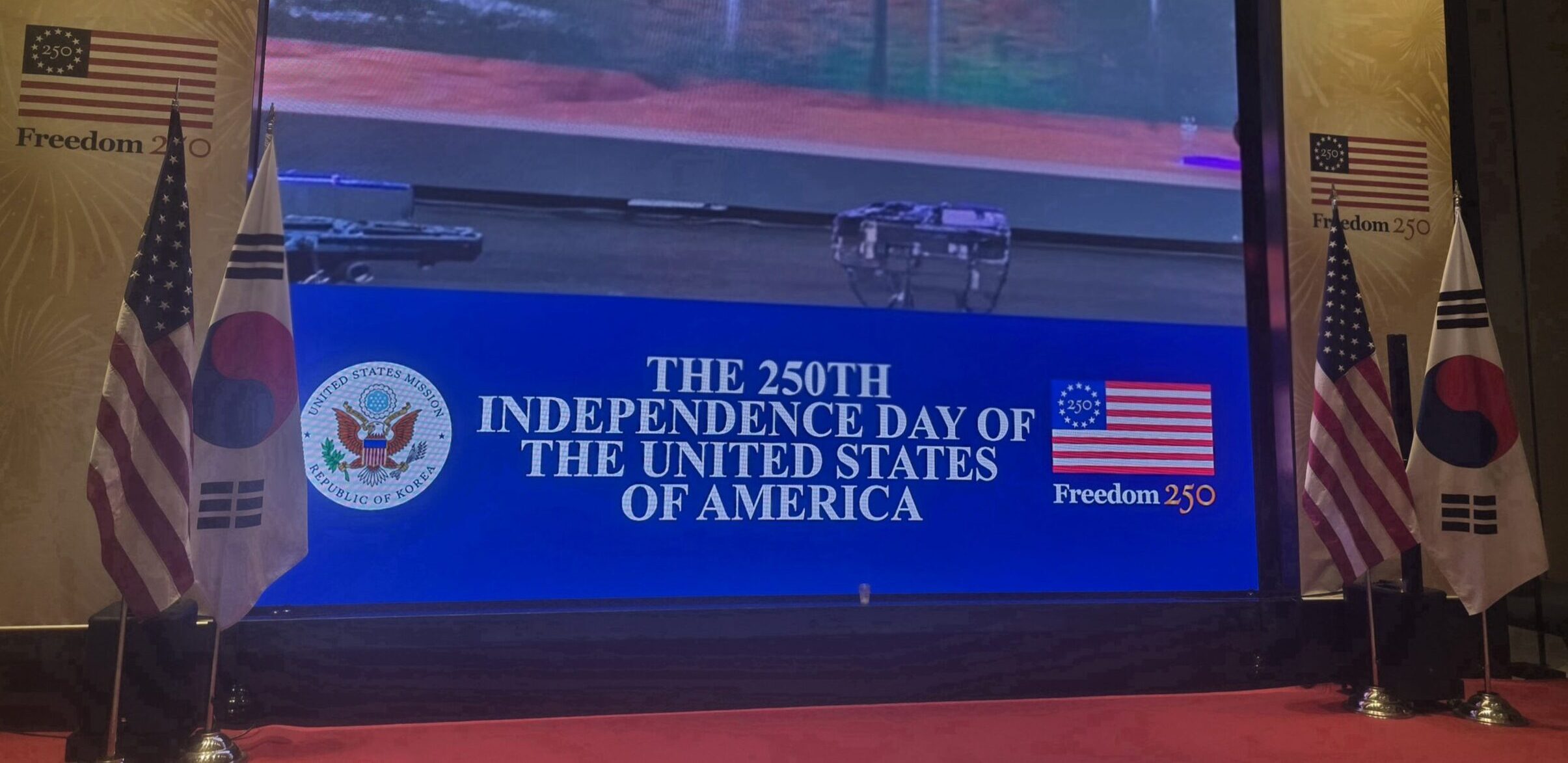 us-embassy-fourth-of-july-reception-seoul-stage Stage at the U.S. Embassy Fourth of July Reception in Seoul, featuring the flags of the United States and South Korea.
